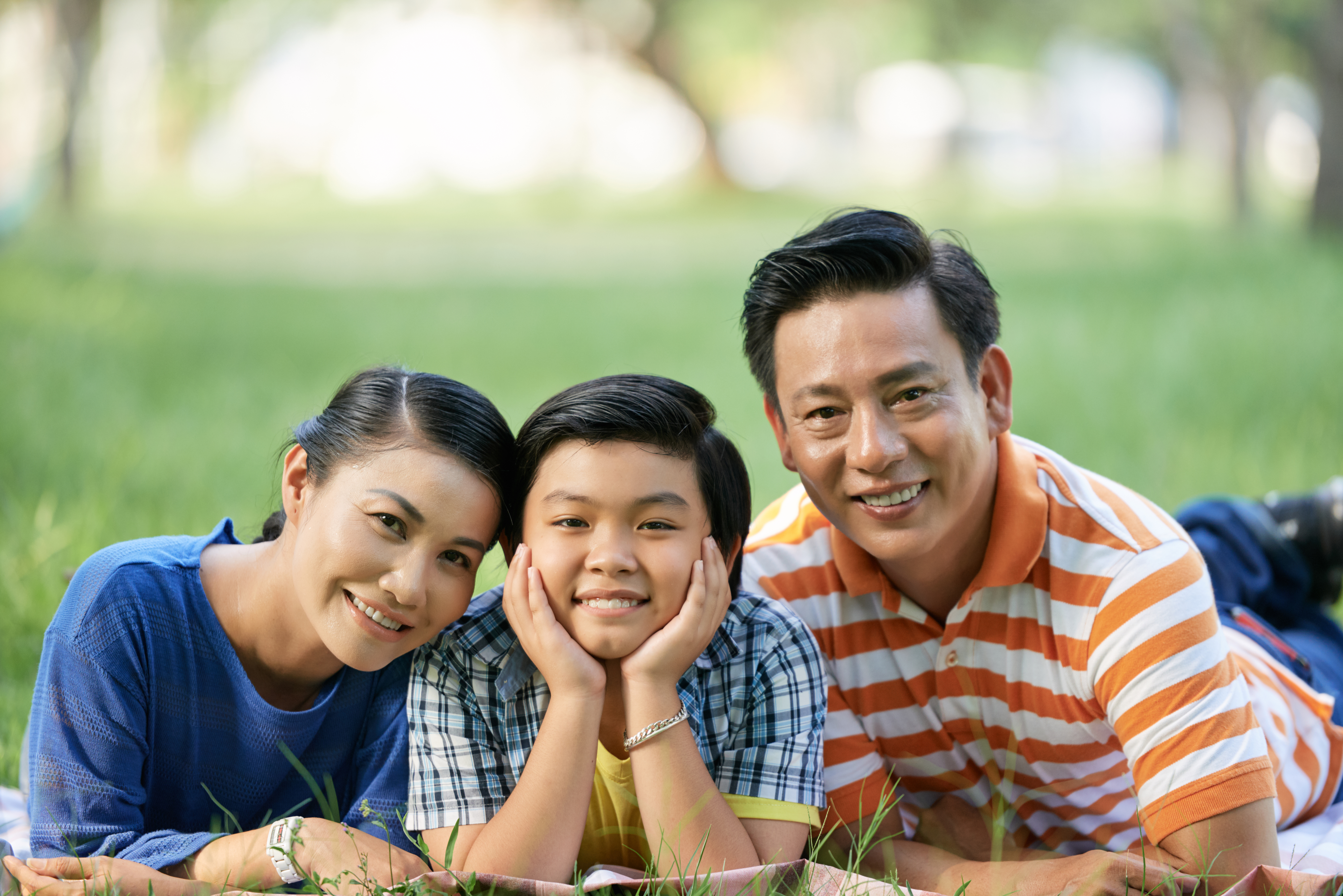 Family relaxing together in a green park
